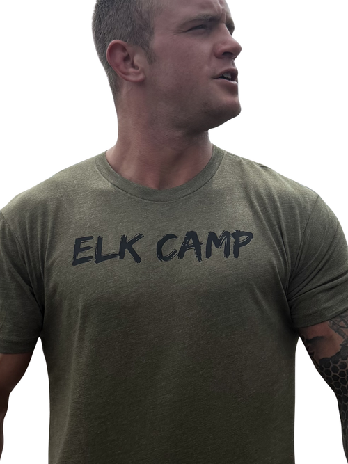 Man wearing a green t-shirt with 'ELK CAMP' text on a white background
